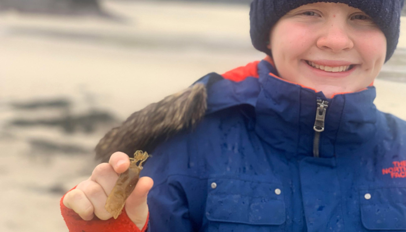 Maia with a wee mermaid purse she found at the high tide line, Clachtol beach.