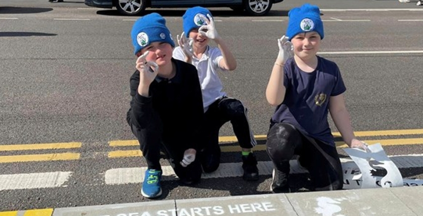 Ullapool Sea Savers ‘refresh’ spray-paint Drain Campaign slogans in village